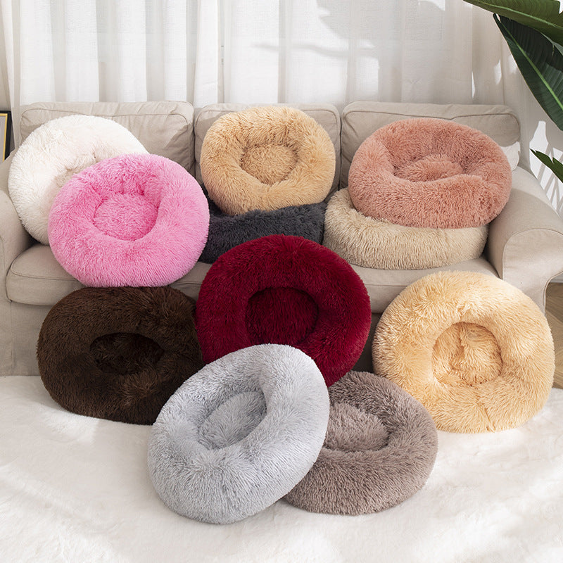Fluffy donut beds in several colours on a sofa