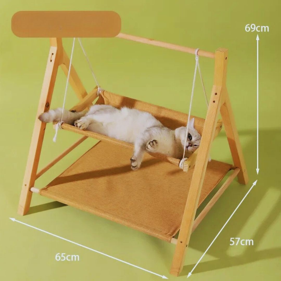 A cat stretched out in the tan swing hammock, with the bed's size: 65 cm long, 57 cm deep, 69 cm high