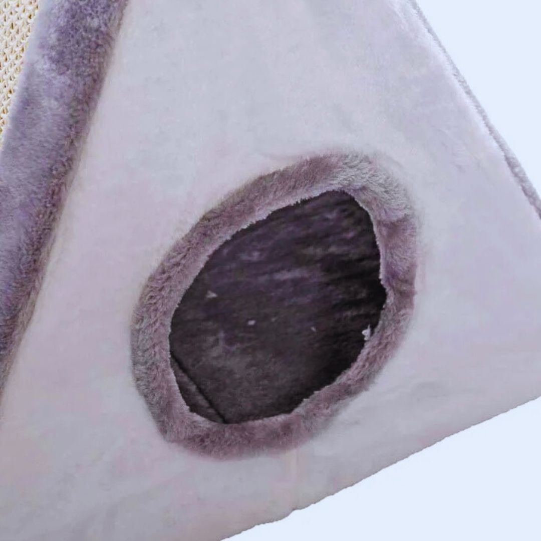 Close view of the round plush-edged entrance in the grey cat house