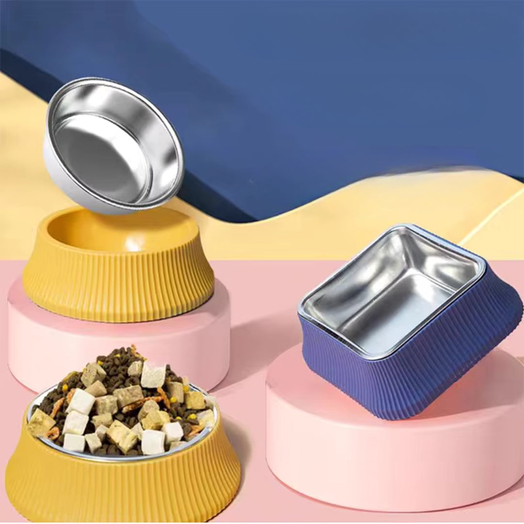 Yellow round and blue square ribbed dog bowls, one steel insert lifted out and one bowl filled with food