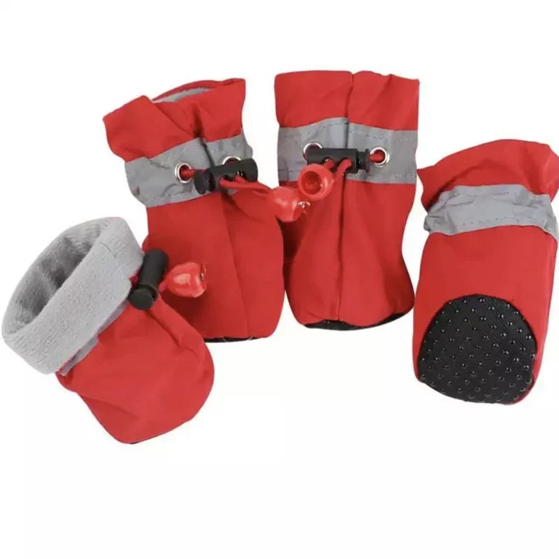 Four red fleece-lined dog boots with grey reflective bands, drawstring toggles and a dotted non-slip sole