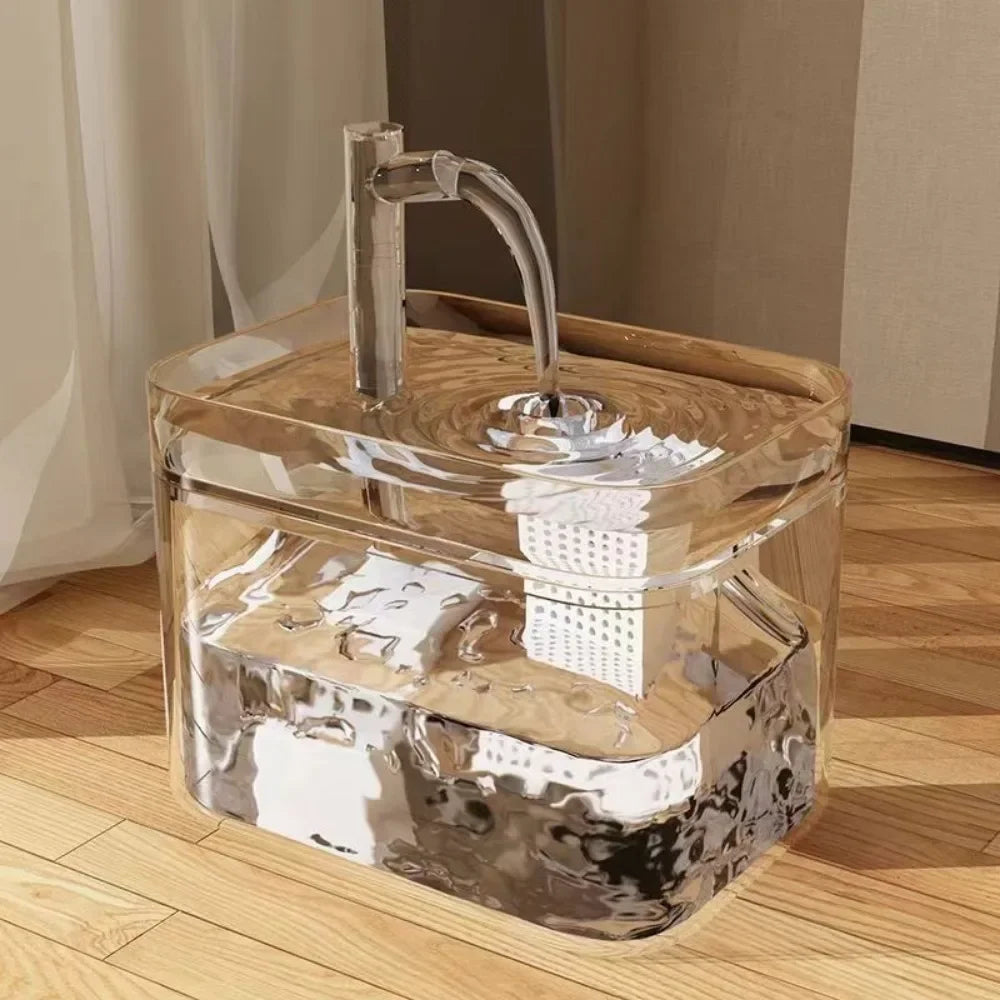 Clear pet water fountain on a wooden floor, seen from the front
