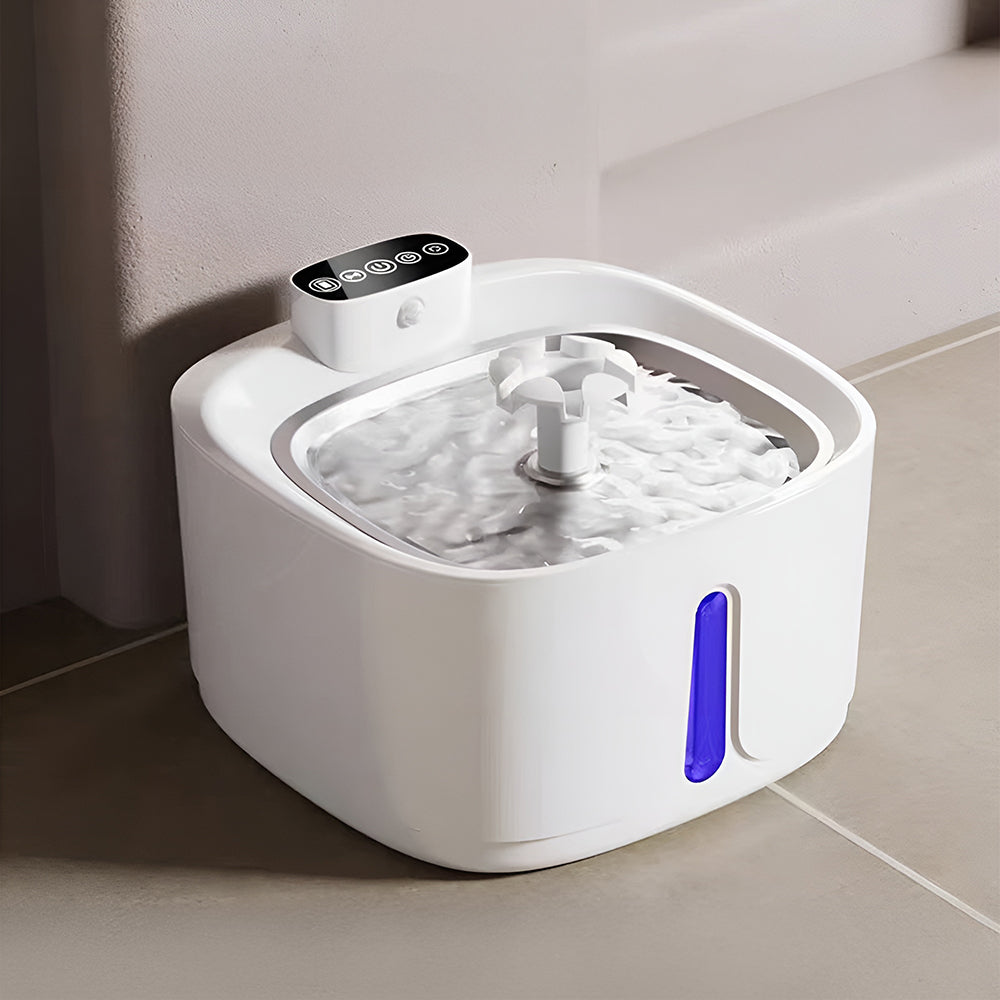 The square white water fountain with water bubbling over its steel tray