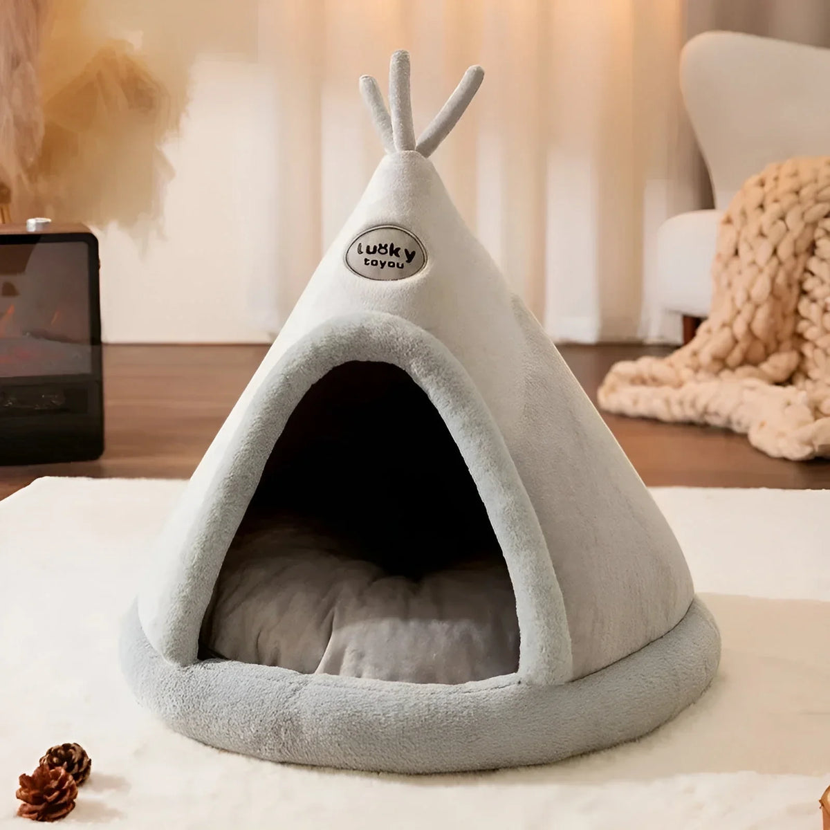 Light grey teepee cave cat bed with a grey sprig on top and a cushion inside