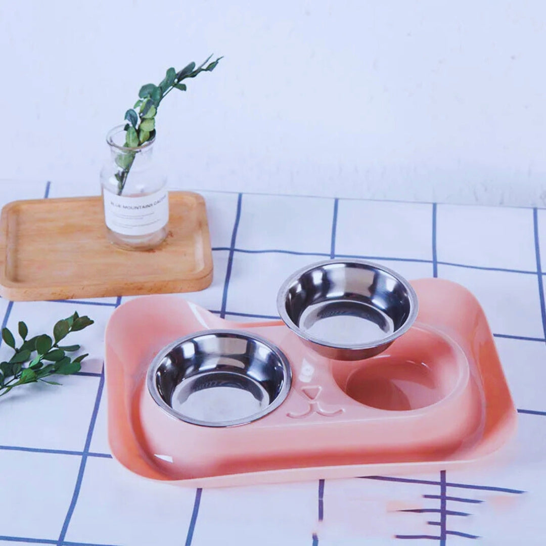 Peach cat-shaped double bowl set with one stainless steel bowl lifted out
