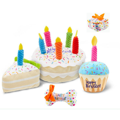 Plush birthday dog toys together: a candle cake, a slice of cake, a cupcake, a bone and a small gift box