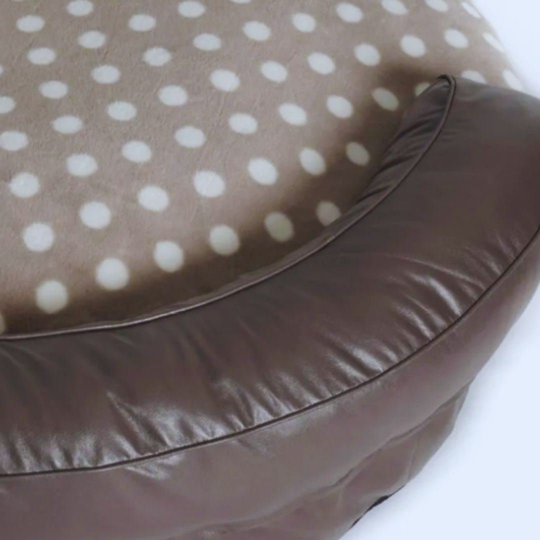Close view of the taupe leather-look bolster and the polka-dot plush seat