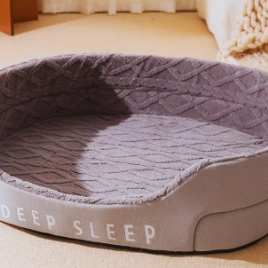 Lilac grey oval pet bed with a thick plush base and raised sides