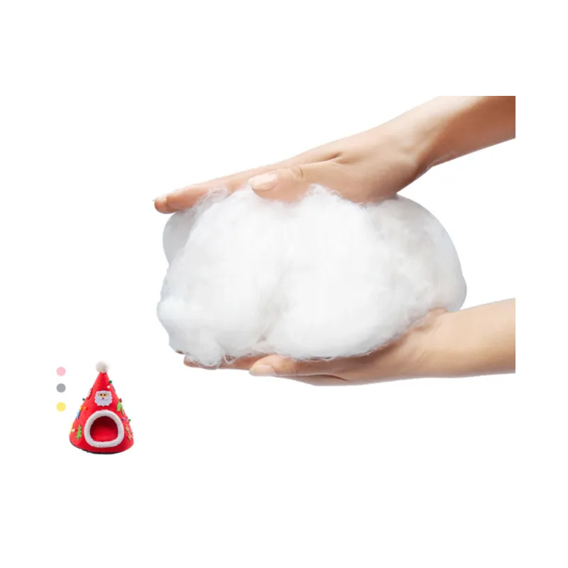 A handful of soft white fibre padding held in two hands, with a small view of the red Christmas tree cave bed