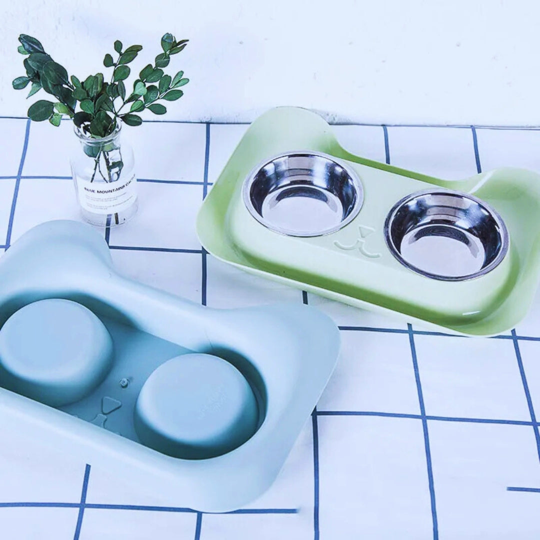 Light green double bowl set with its two steel bowls beside a mint tray turned over