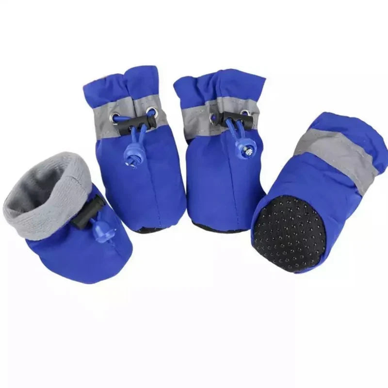 Four blue fleece-lined dog boots with grey reflective bands, drawstring toggles and a dotted non-slip sole
