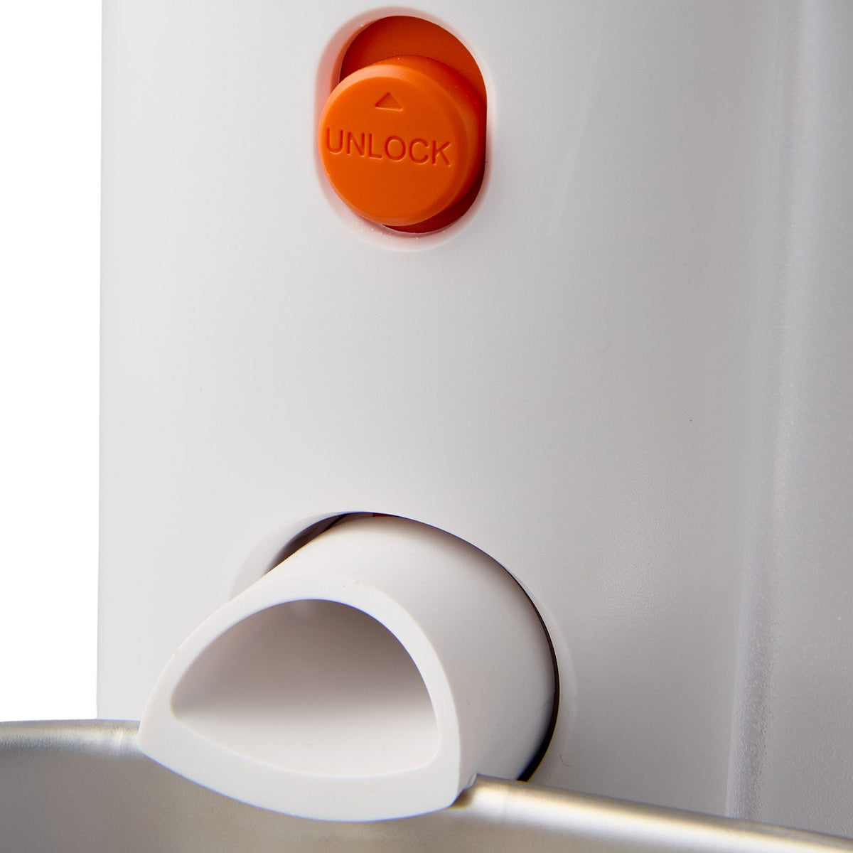 Close view of the orange unlock button and the water spout of the fountain