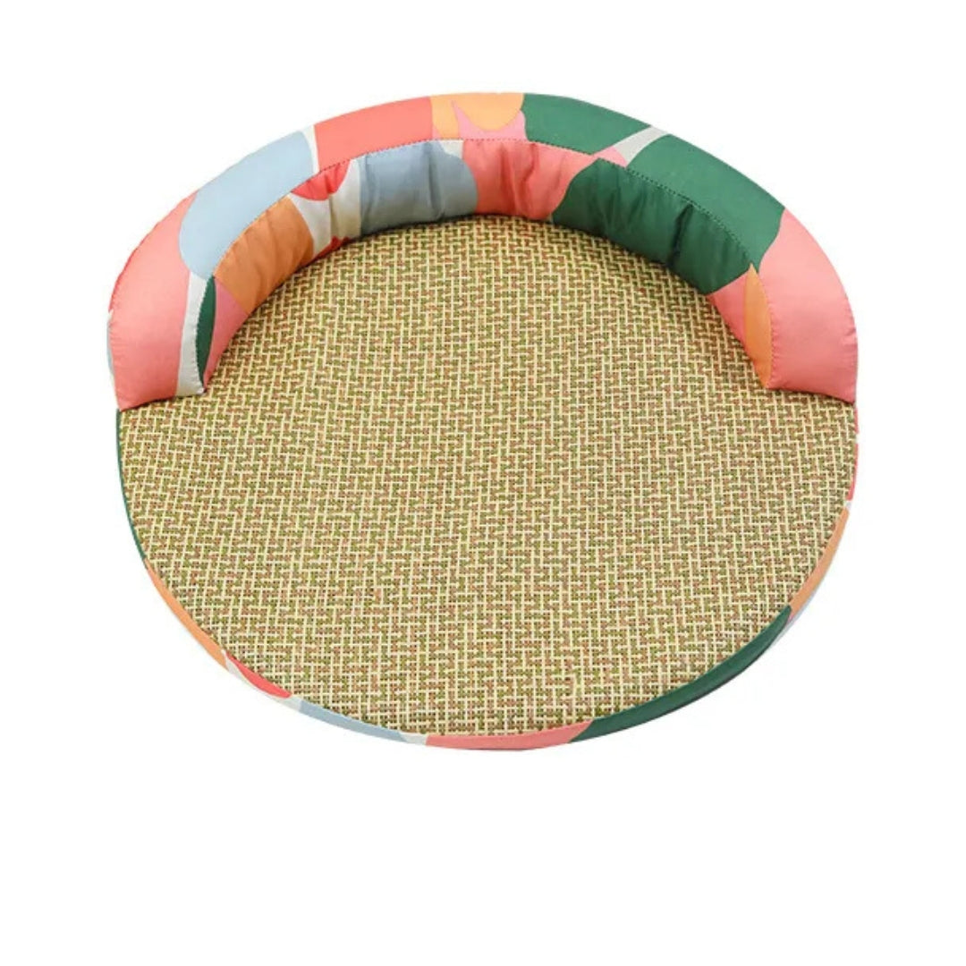 Colour block round cat bed seen from the front, the padded rim round the back half