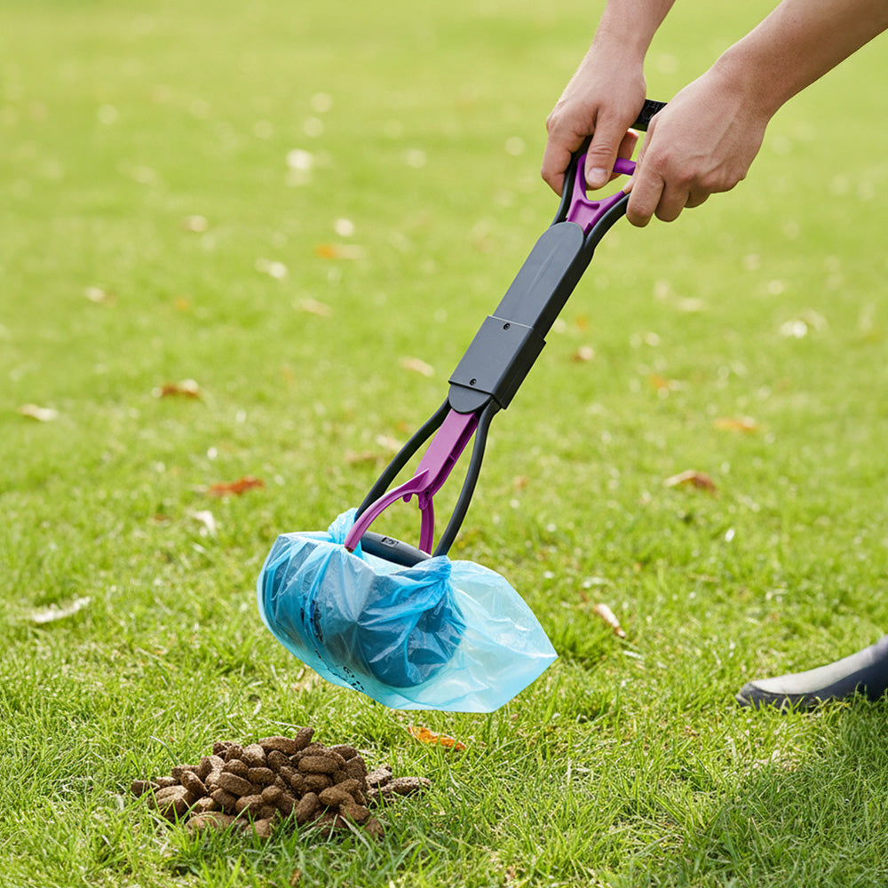 The purple scoop with a blue waste bag over the jaws, on grass