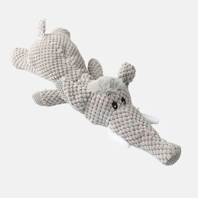 Grey plush elephant dog toy with white tusks