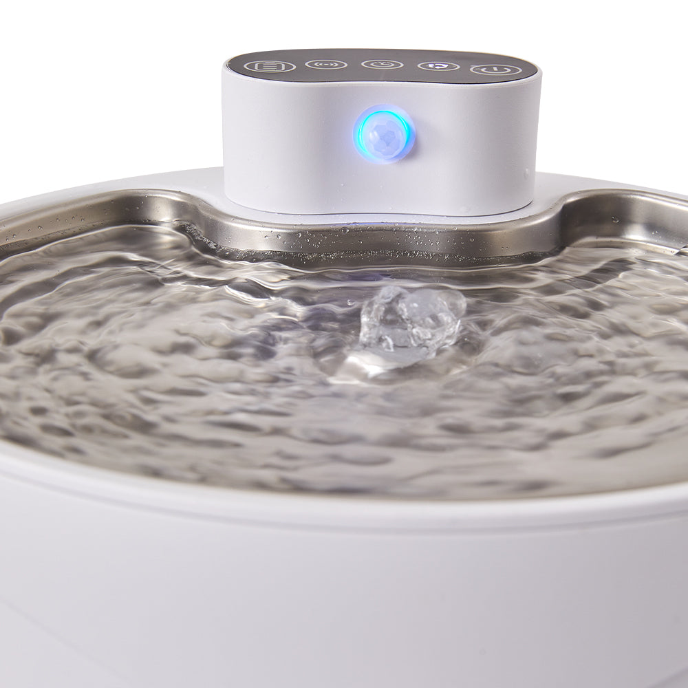 Close-up of water welling up over the centre spout, the blue light on the control module