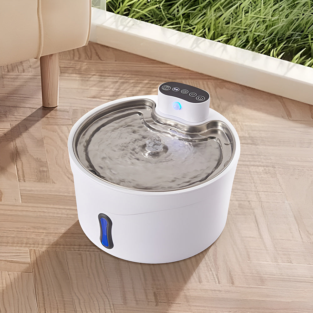 White pet water fountain with water flowing over the steel tray and a blue light on the control module