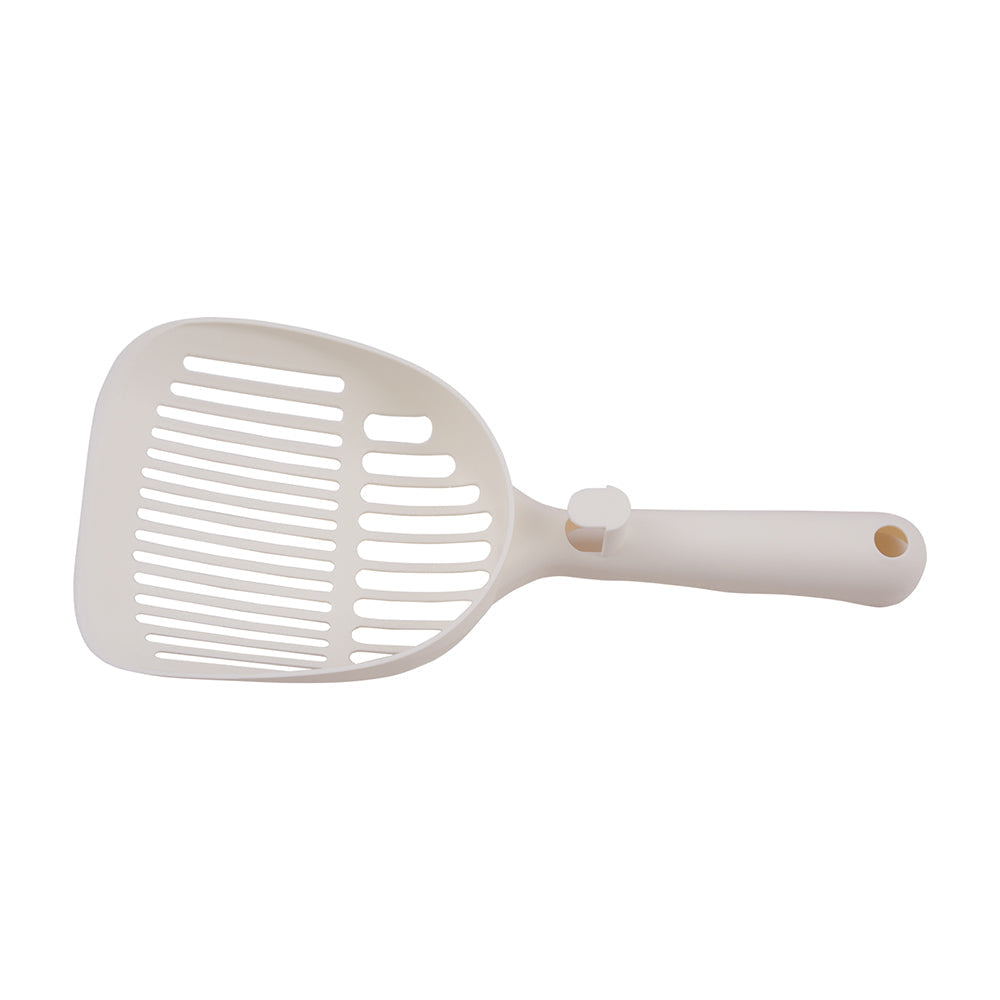 The white litter scoop included with the hooded litter box