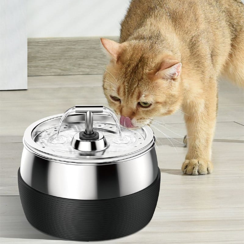 Ginger cat drinking from the stainless steel fountain with a T-shaped double spout