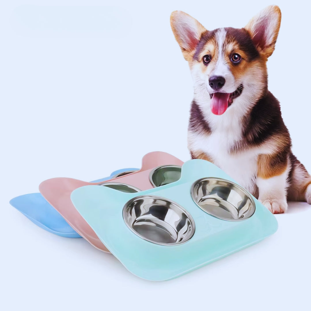 Mint, peach and blue cat-shaped double bowl sets stacked, with a corgi sitting behind them