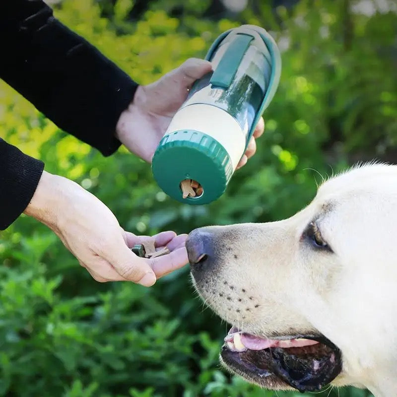 Shaking treats from the bottle's food container into a hand for a Labrador