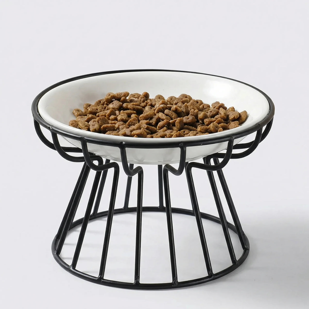 The raised ceramic bowl in its black stand filled with dry food