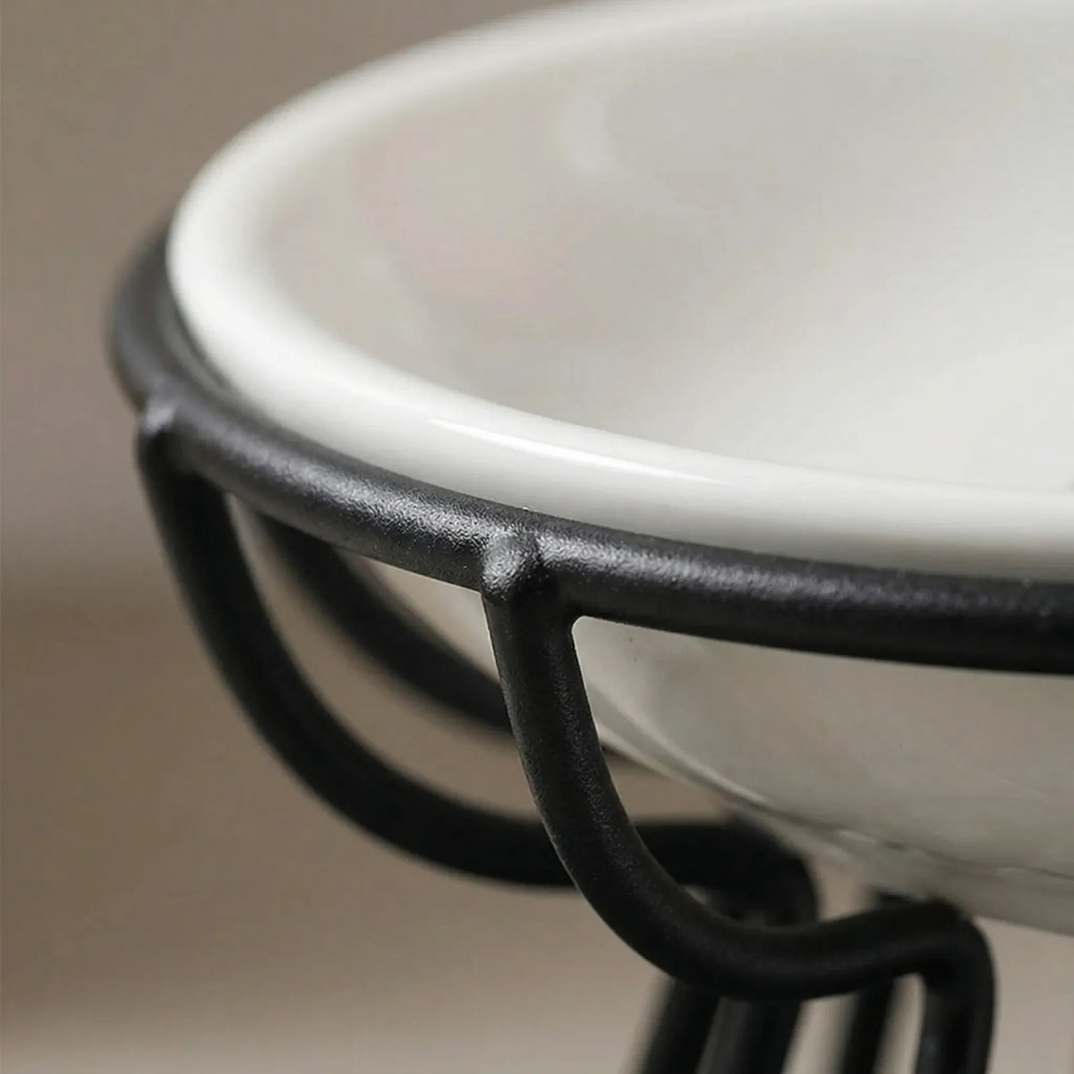 Close-up of the ceramic bowl resting in the black wire ring