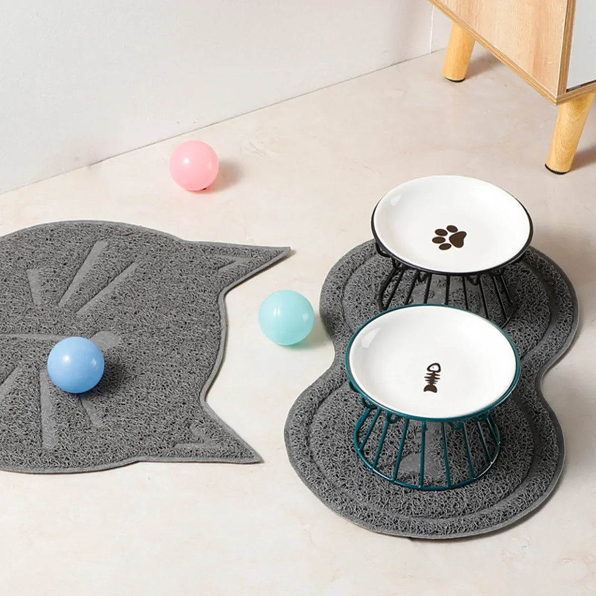 Two raised bowls on grey cat-shaped mats