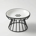 White ceramic cat bowl with a grey paw print in a raised black wire stand