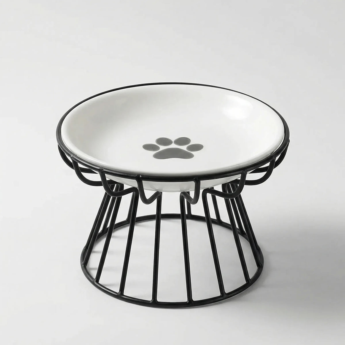 White ceramic cat bowl with a grey paw print in a raised black wire stand
