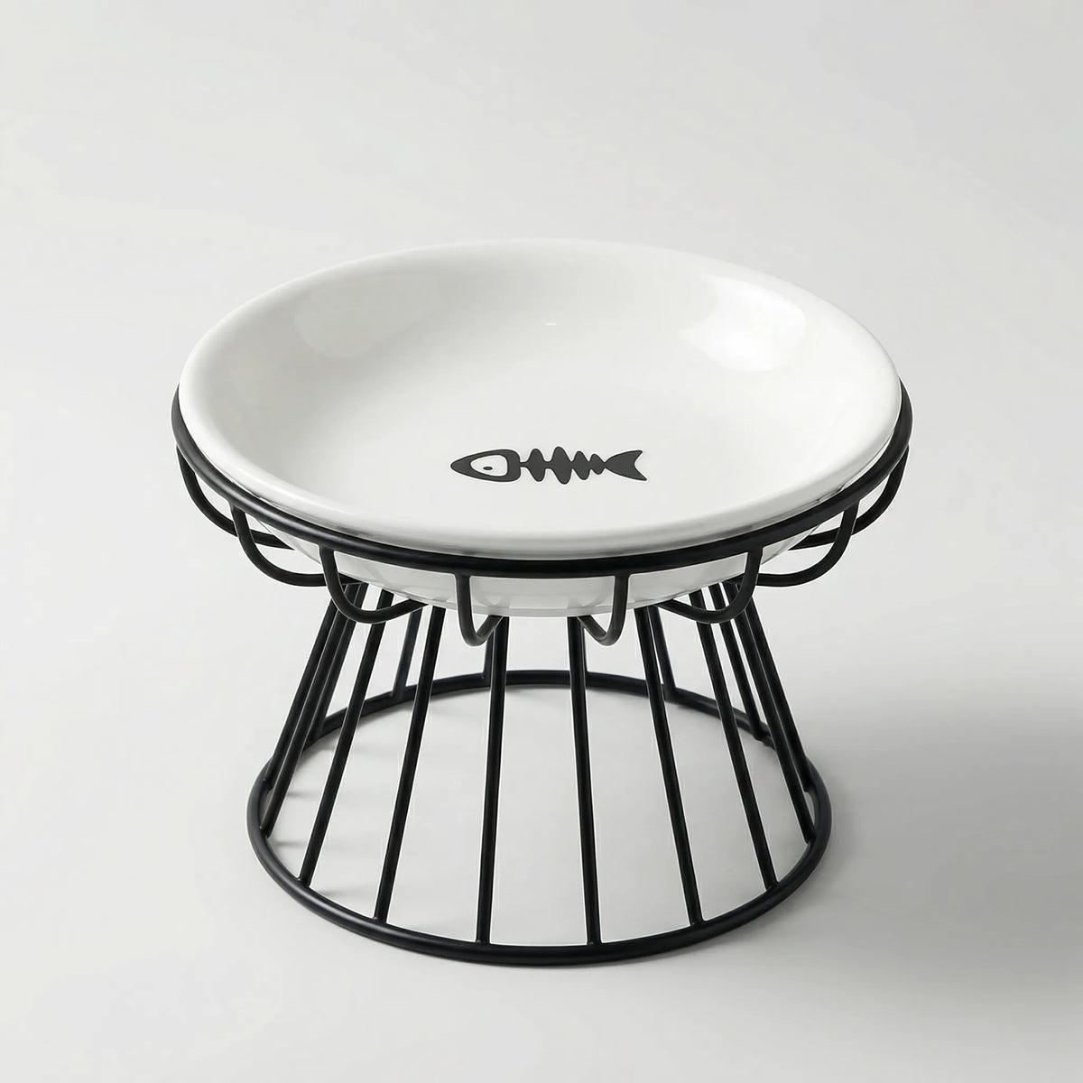 White ceramic cat bowl with a fish-bone print in a raised black wire stand