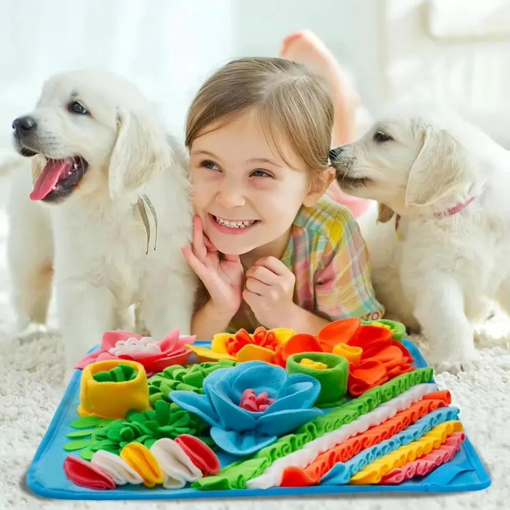 A girl and two puppies with the flower snuffle mat