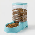 Blue gravity pet feeder with a clear reservoir full of dry food