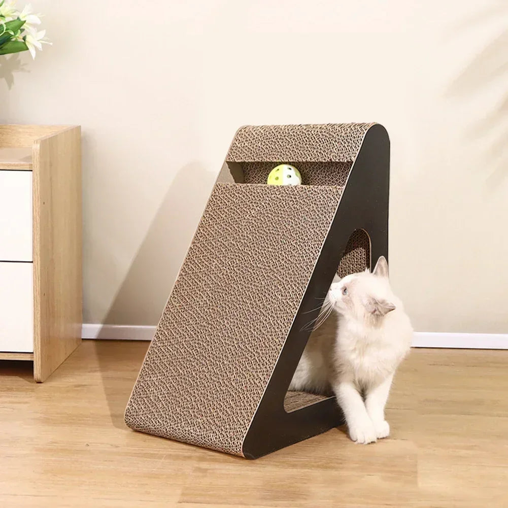 A white kitten peeking out from the opening in the side of the scratcher