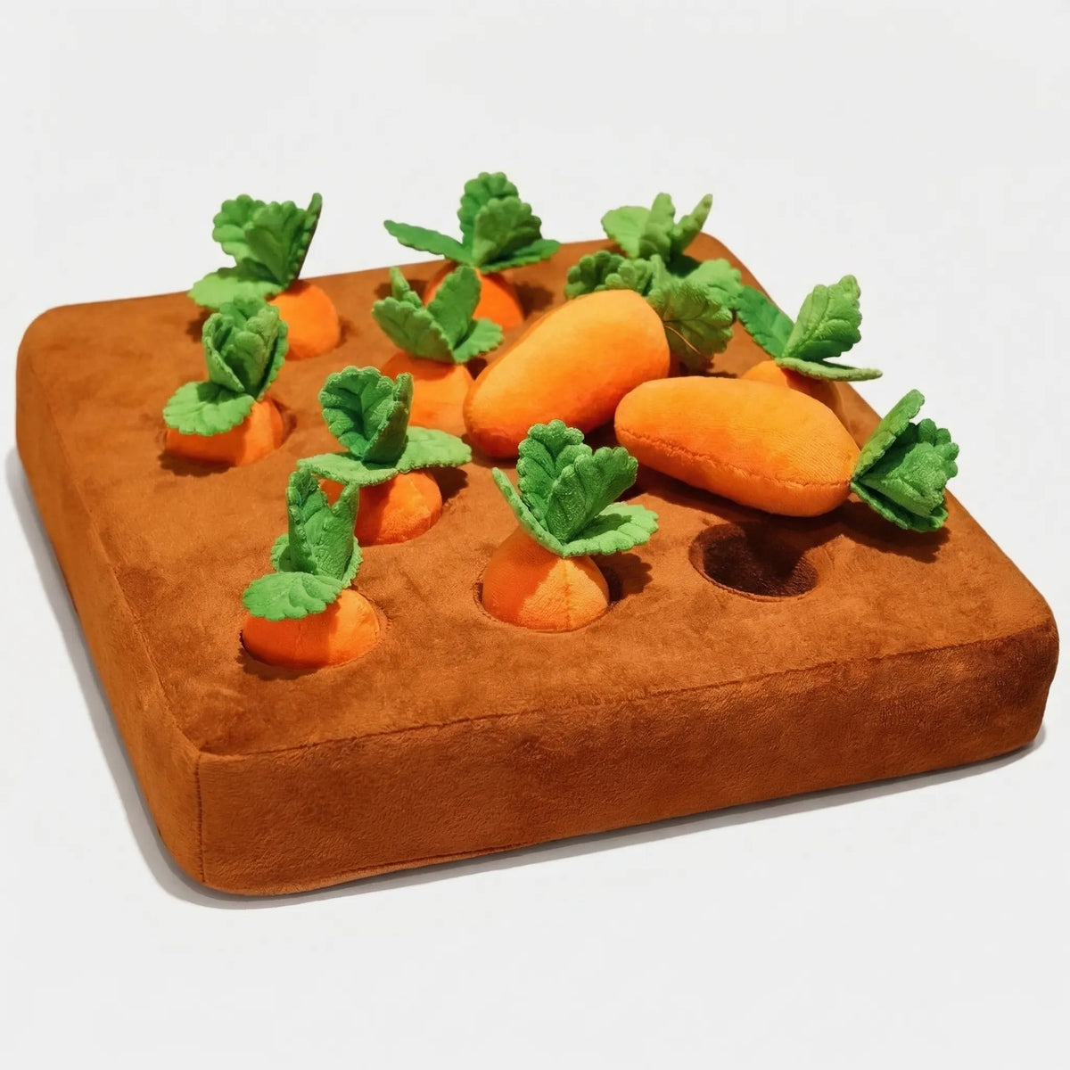 The plush vegetable patch with twelve plush carrots, one lying on top