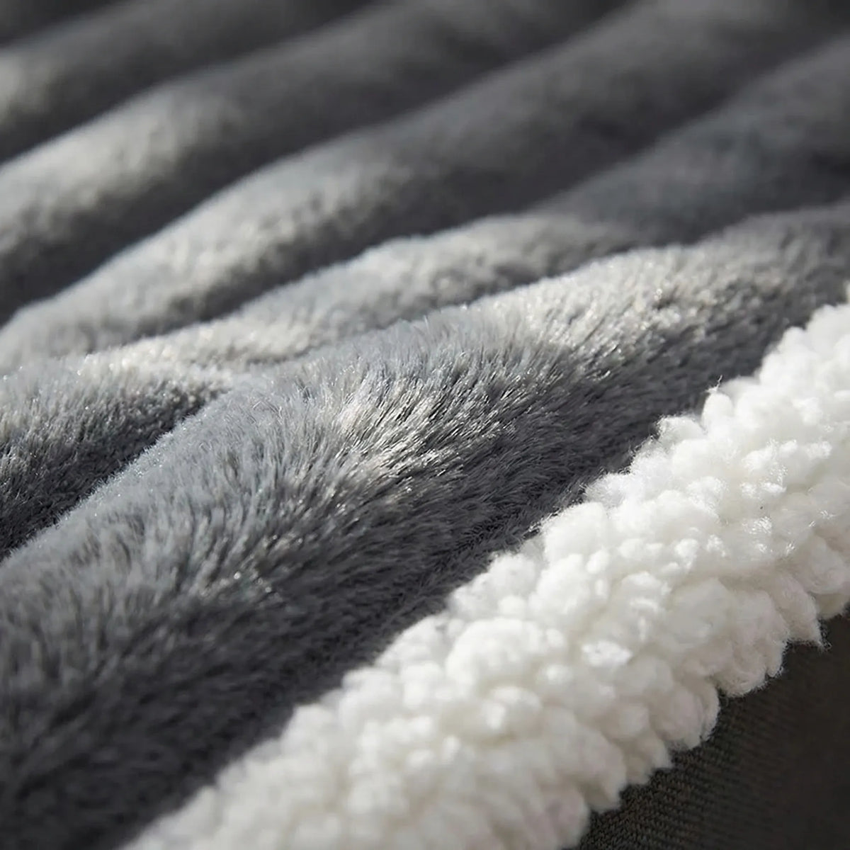 Close-up of the grey ribbed plush and the white fleece edge