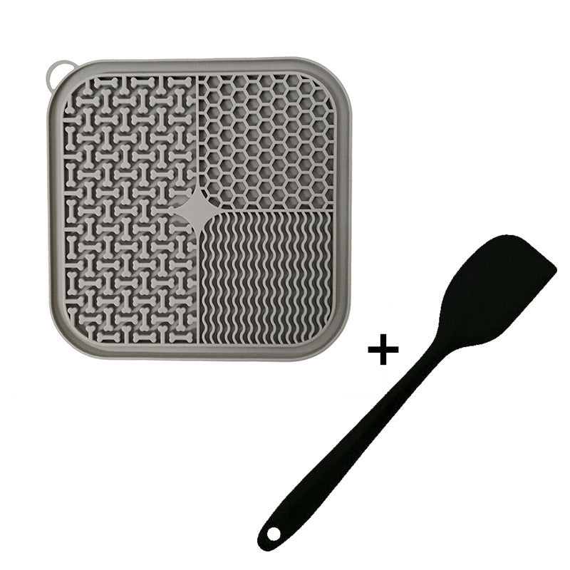 Grey silicone lick mat with a matching black spatula