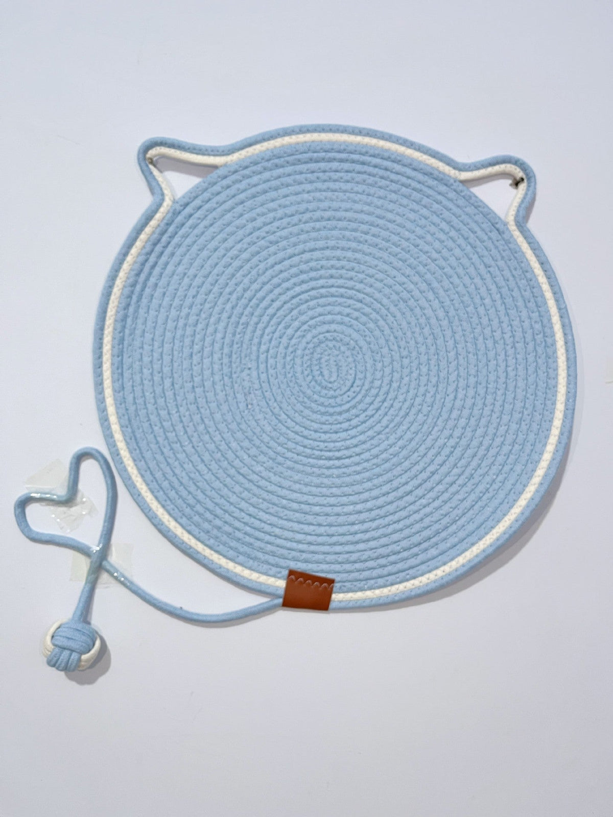 Blue coiled rope scratching mat with a white edge and a rope ball toy