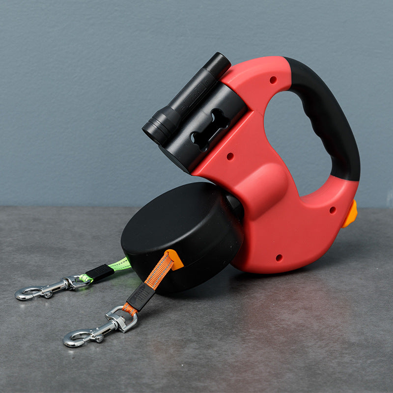 Red retractable double dog lead on a grey surface