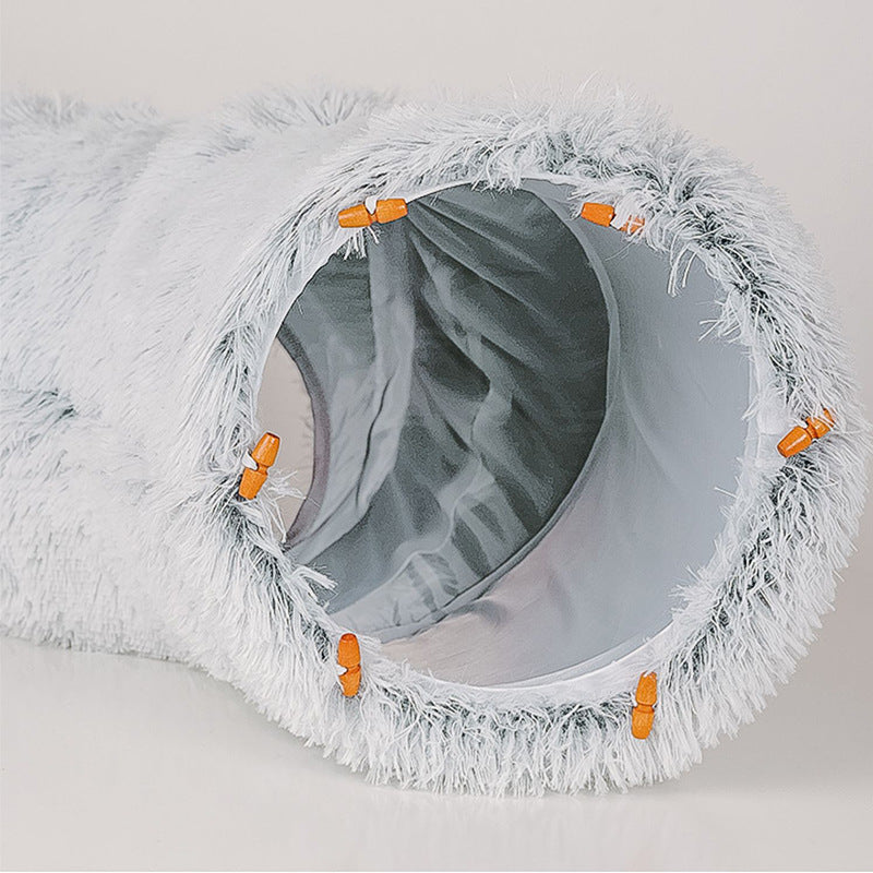 Close-up of the tunnel opening of the light grey plush bed, lined with smooth grey fabric
