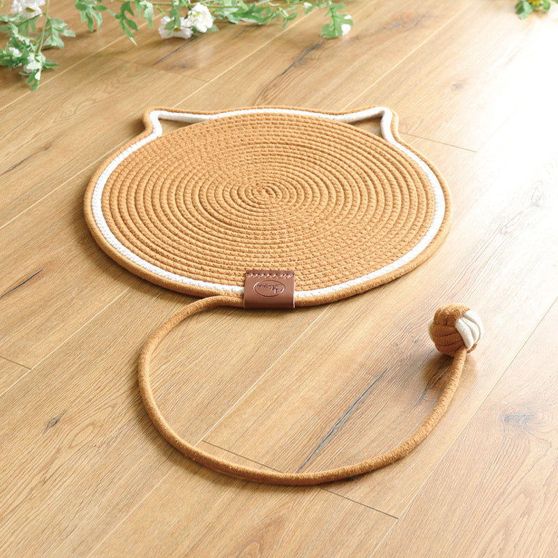 Caramel coiled rope scratching mat with a white edge and a rope ball toy