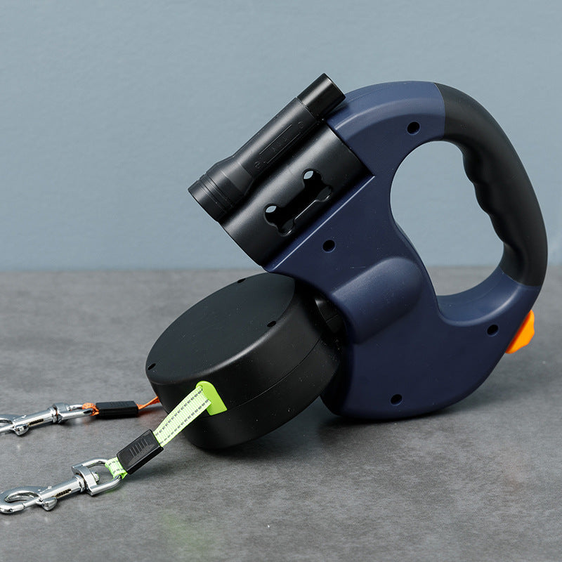 Navy blue retractable double dog lead on a grey surface