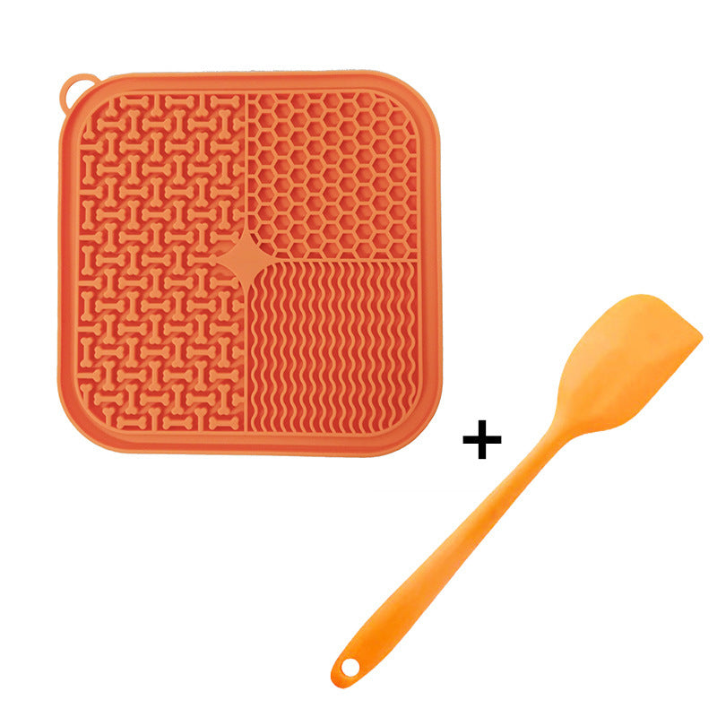 Orange silicone lick mat with a matching orange spatula