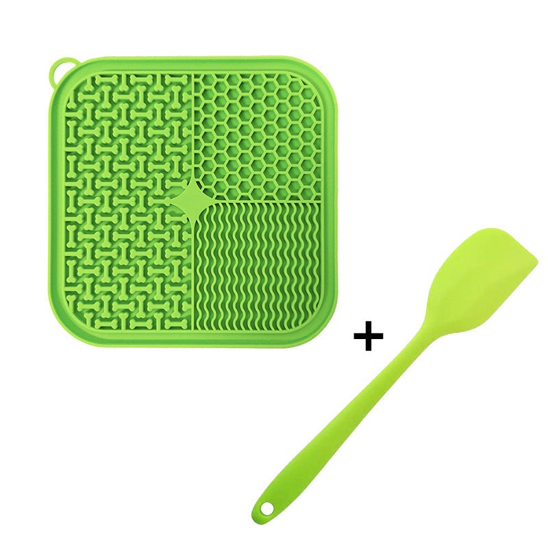 Green silicone lick mat with a matching green spatula