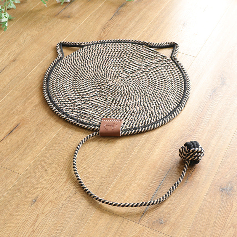 Black and white coiled rope scratching mat with a black edge and a rope ball toy