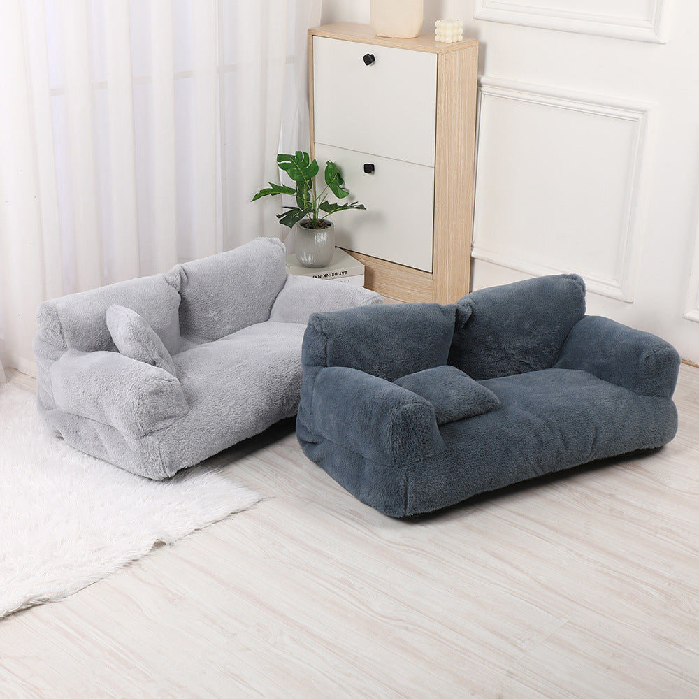 A light grey and a dark grey plush dog sofa side by side in a bright room