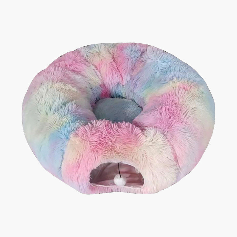 Pastel rainbow plush cat tunnel bed in pink, blue and lilac with a white pompom in the tunnel opening