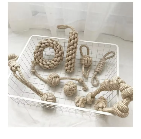 Cotton rope dog toys arranged in a white wire basket