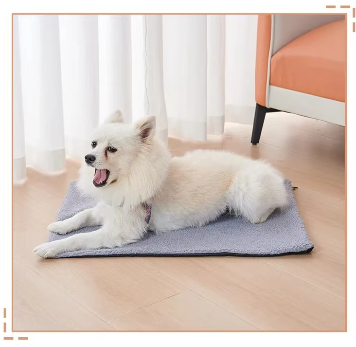 White spitz dog lying on a grey version of the self-warming mat by an armchair