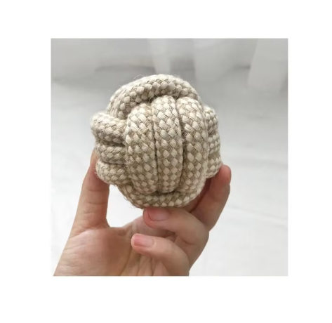 Cotton rope ball dog toy held in one hand